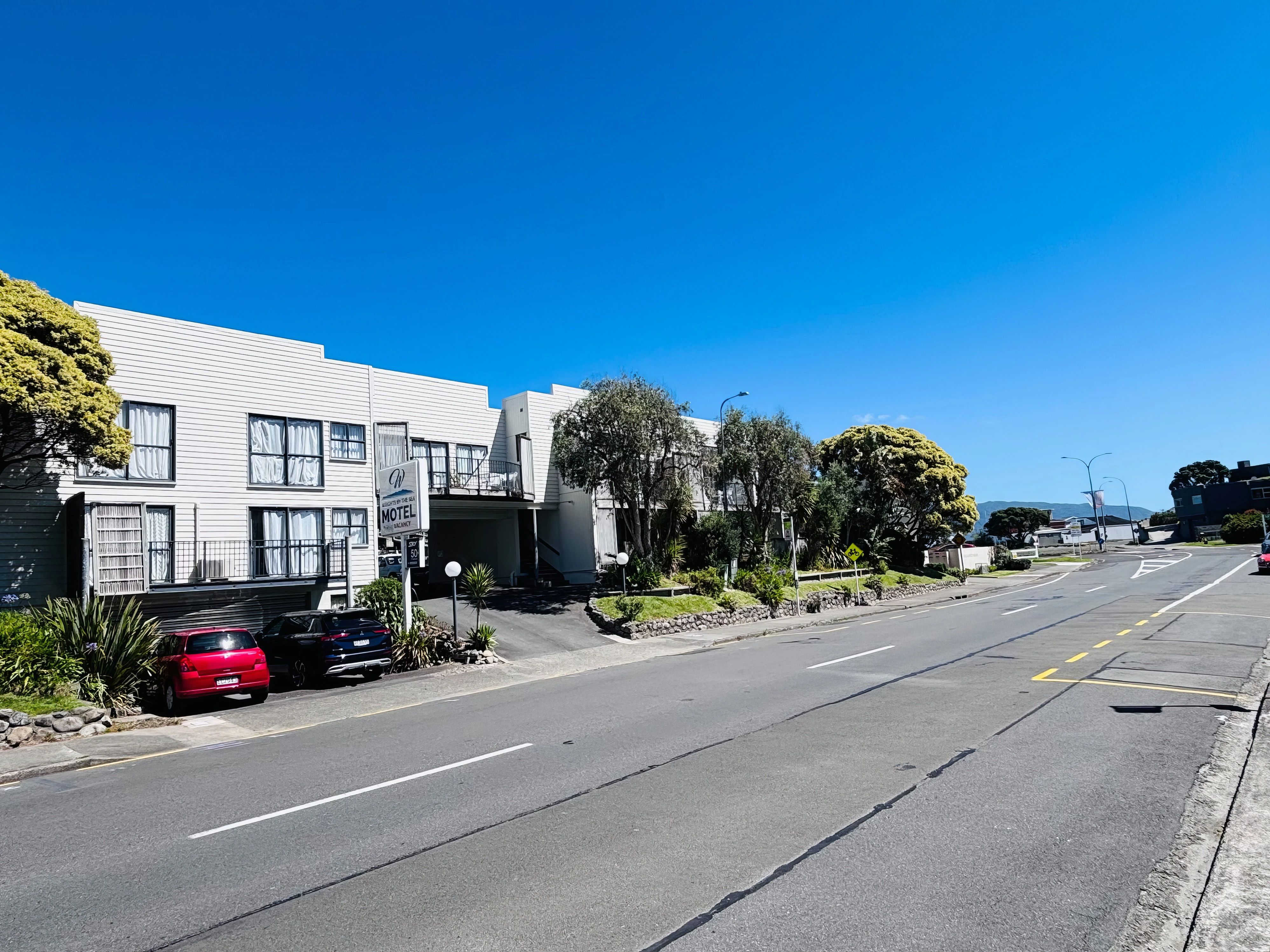 Wrights by the Sea Motel frontage, roadside sign and driveway on Kapiti Road